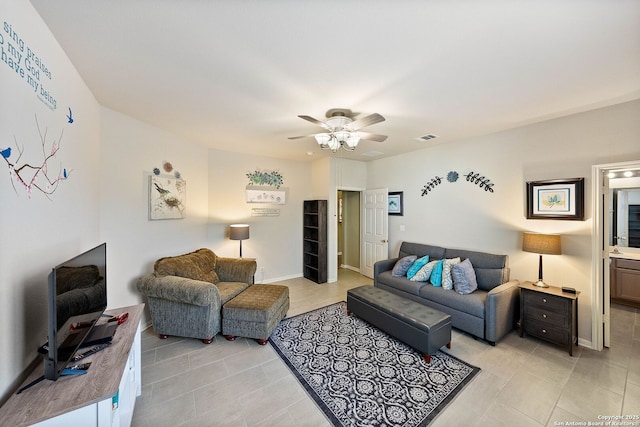 living area featuring baseboards, visible vents, a ceiling fan, and light tile patterned flooring