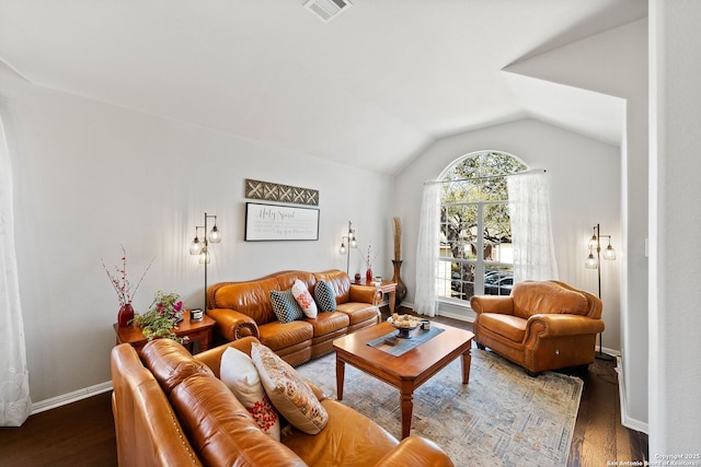living area featuring lofted ceiling, wood finished floors, visible vents, and baseboards