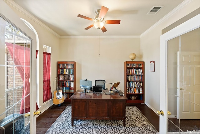office space with dark wood-style floors, crown molding, a ceiling fan, visible vents, and baseboards