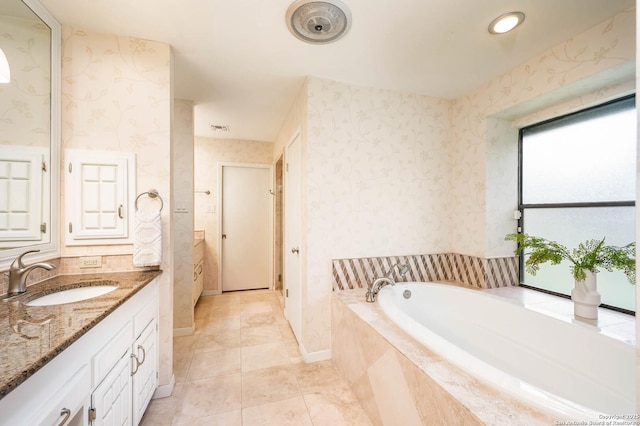 bathroom with vanity, tile patterned floors, a garden tub, and wallpapered walls