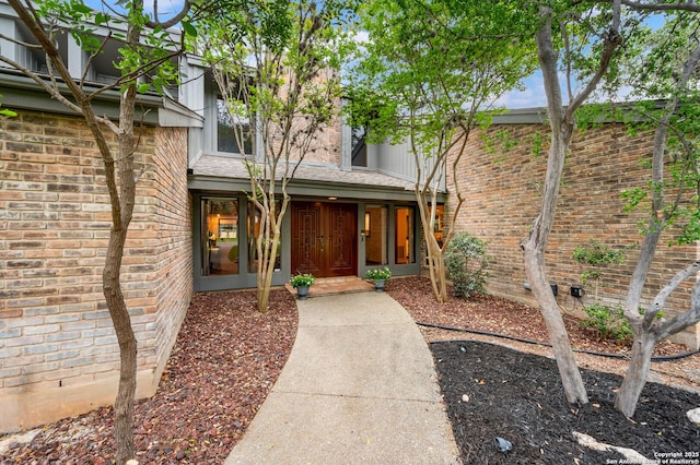 doorway to property with brick siding