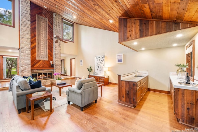 living room with high vaulted ceiling, light wood-style flooring, recessed lighting, a ceiling fan, and wooden ceiling