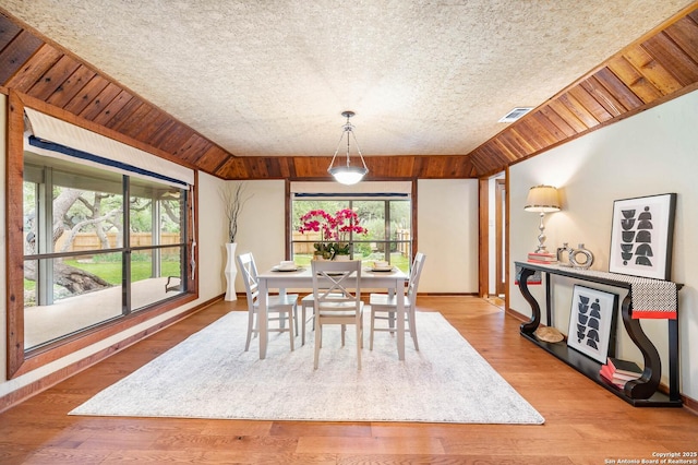dining room with visible vents, baseboards, wood finished floors, and a healthy amount of sunlight