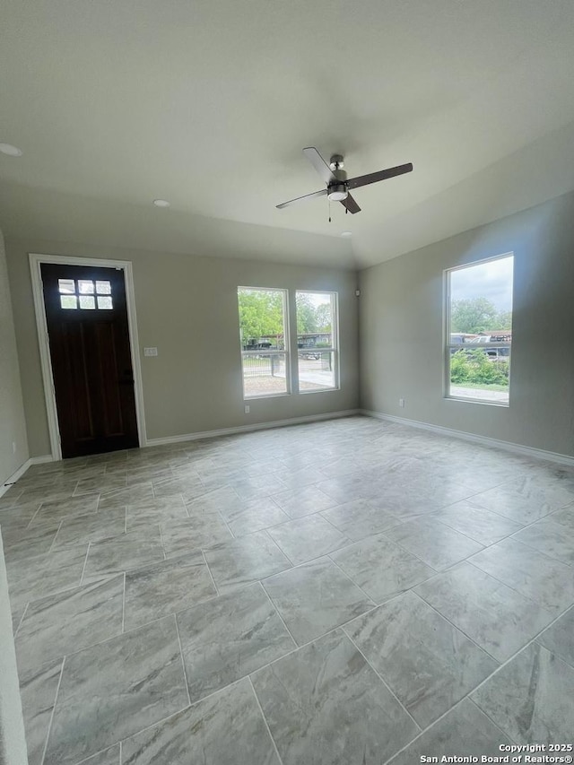 foyer featuring ceiling fan and baseboards