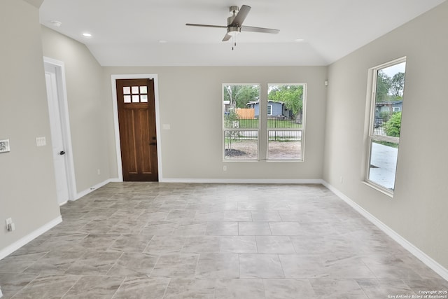 foyer with a wealth of natural light, ceiling fan, and vaulted ceiling