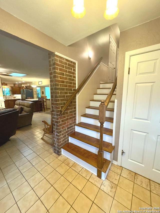 stairs with tile patterned floors