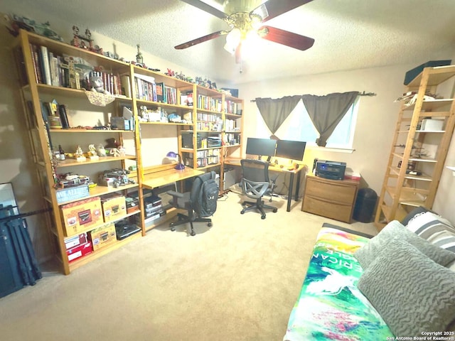carpeted home office featuring ceiling fan and a textured ceiling