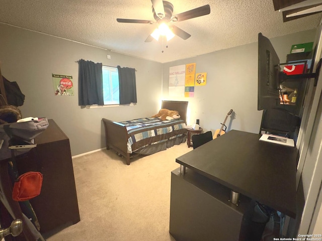 carpeted bedroom featuring a textured ceiling and ceiling fan