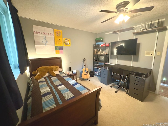 carpeted bedroom featuring a textured ceiling and a ceiling fan