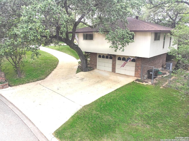 view of home's exterior with a yard, brick siding, a shingled roof, a garage, and concrete driveway