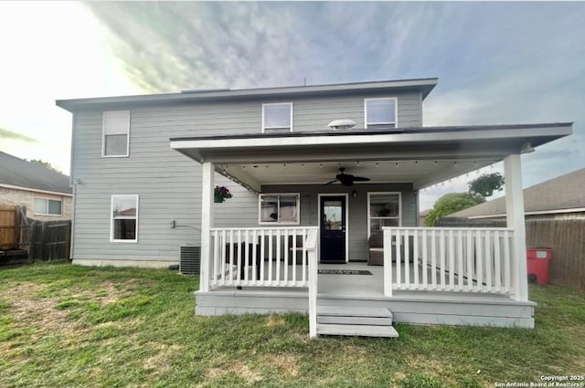 back of property featuring a porch, a lawn, ceiling fan, and fence