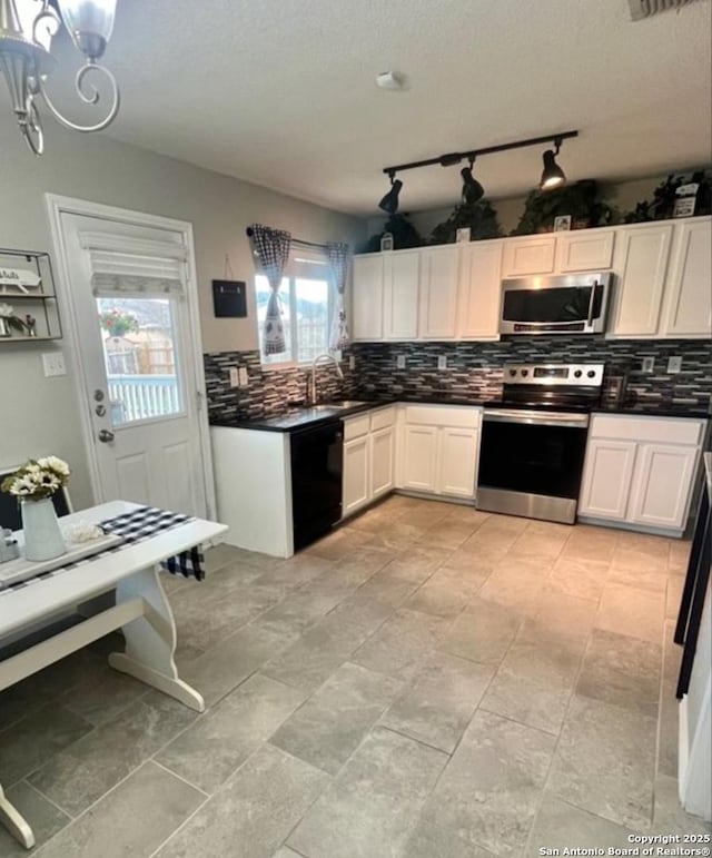 kitchen with appliances with stainless steel finishes, dark countertops, decorative backsplash, and white cabinets