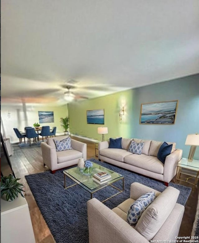 living room with wood finished floors and ceiling fan