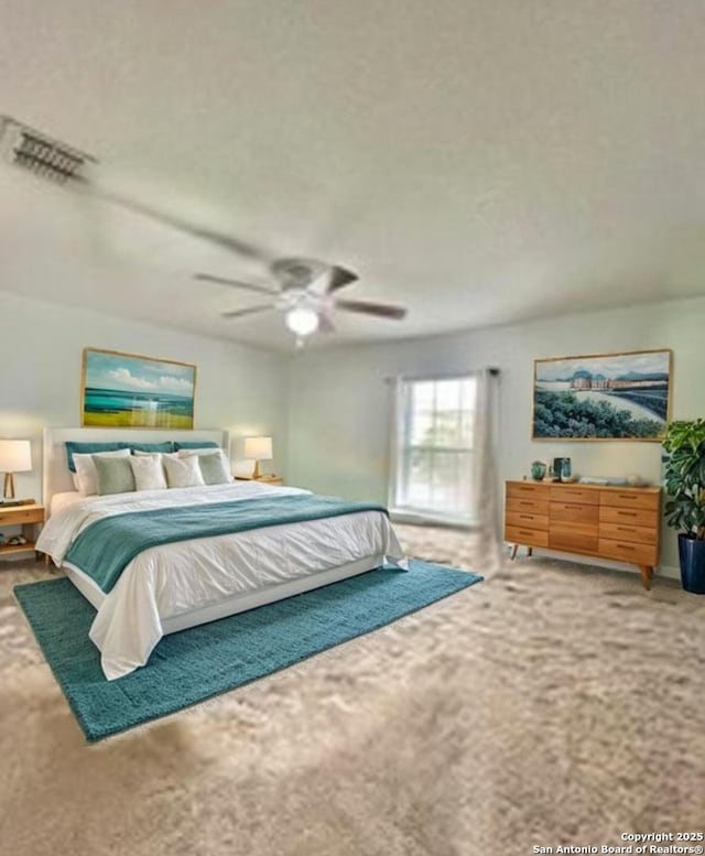 carpeted bedroom with visible vents and a ceiling fan