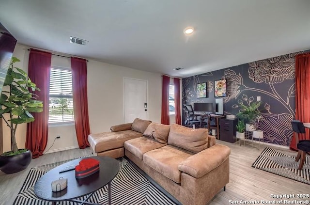 living room featuring light wood finished floors and visible vents