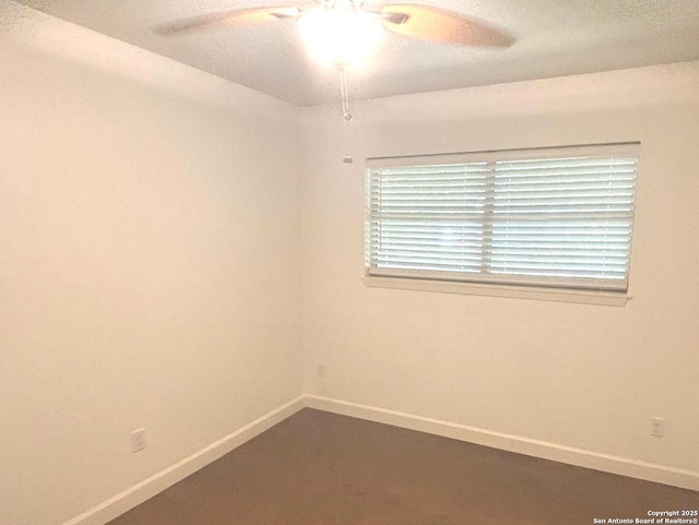 empty room with baseboards and ceiling fan