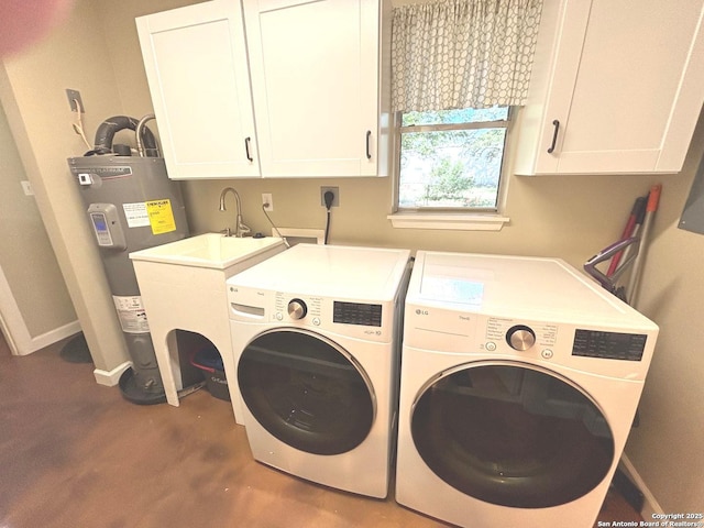 clothes washing area with baseboards, cabinet space, electric water heater, and independent washer and dryer
