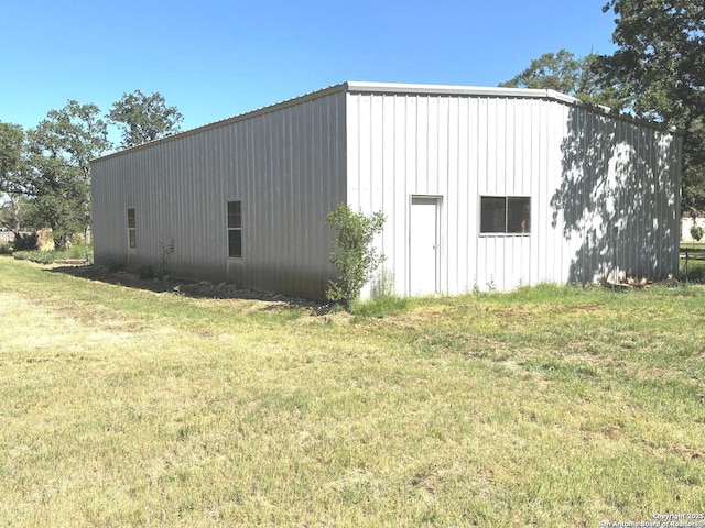 view of pole building with a yard