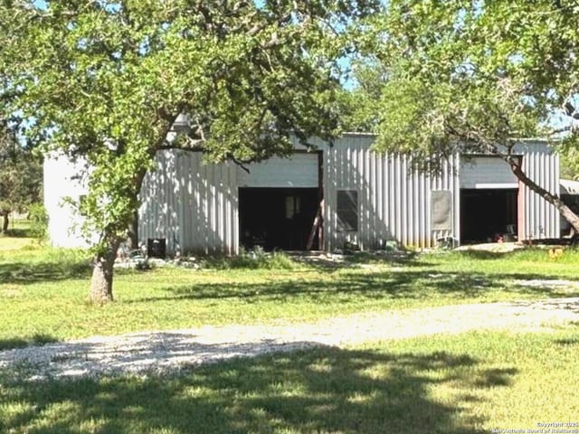 view of pole building with a yard