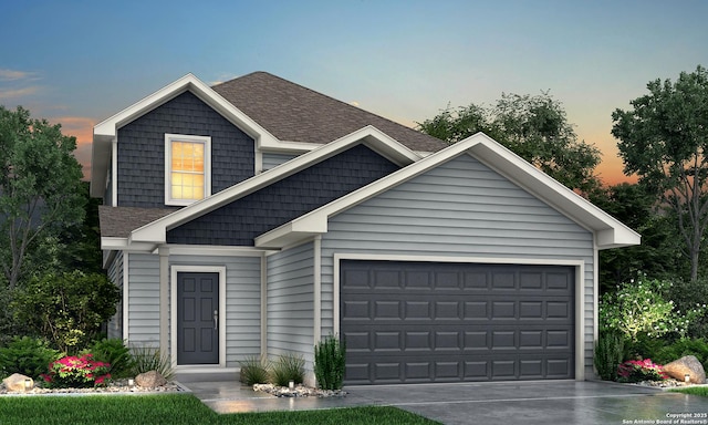 view of front of house featuring a garage, a shingled roof, and driveway