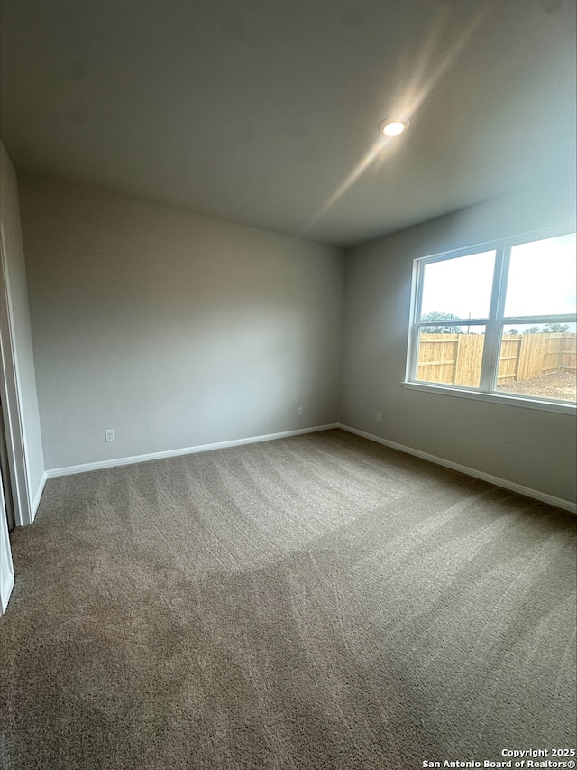 unfurnished room with carpet, recessed lighting, and baseboards