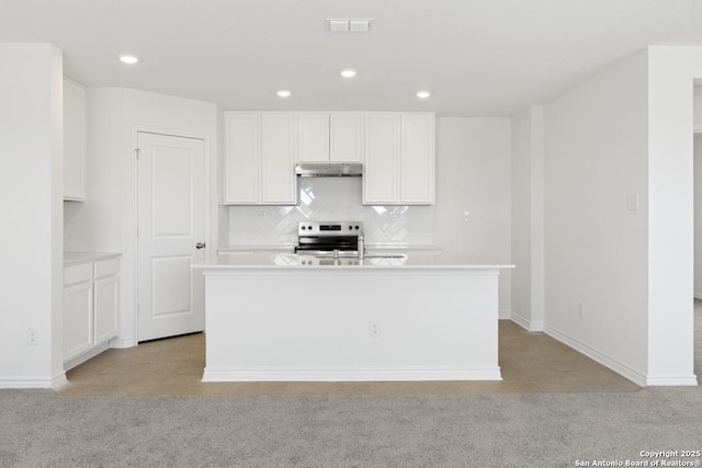 4770 Pico Pico St, San Antonio, TX 78222 - kitchen featuring under cabinet range hood, stainless steel electric range oven, light colored carpet, recessed lighting, and white cabinetry