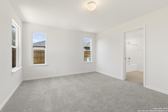 4770 Pico Pico St, San Antonio, TX 78222 - unfurnished bedroom featuring carpet floors, multiple windows, and baseboards