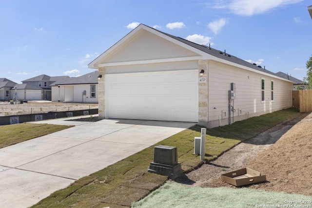 4770 Pico Pico St, San Antonio, TX 78222 - view of side of home with driveway, fence, and a garage