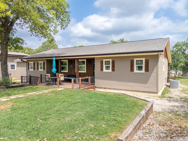 rear view of property with a lawn, central AC, and a patio area
