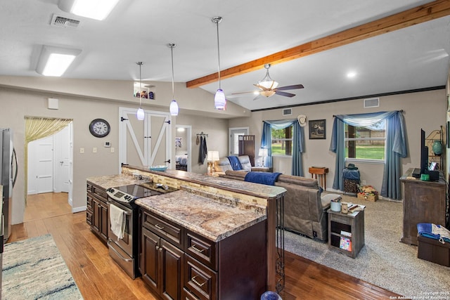 kitchen featuring light wood-style flooring, visible vents, open floor plan, electric stove, and vaulted ceiling with beams