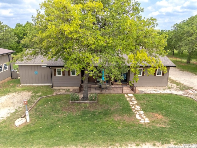 view of front of house with a patio area and a front yard