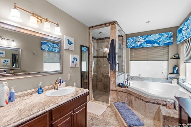 bathroom featuring a shower stall, a garden tub, and vanity