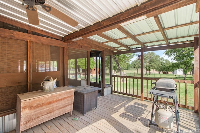 deck with area for grilling, a ceiling fan, a yard, and a sunroom