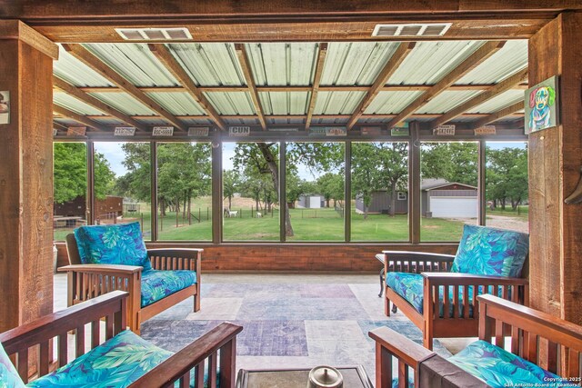sunroom featuring visible vents and plenty of natural light