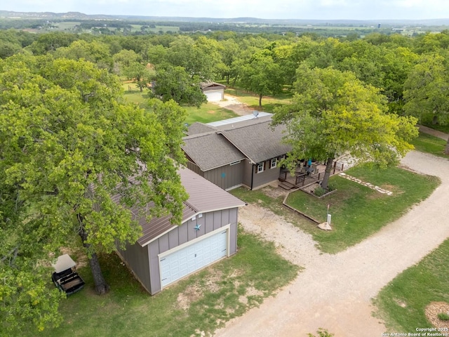 drone / aerial view featuring a wooded view