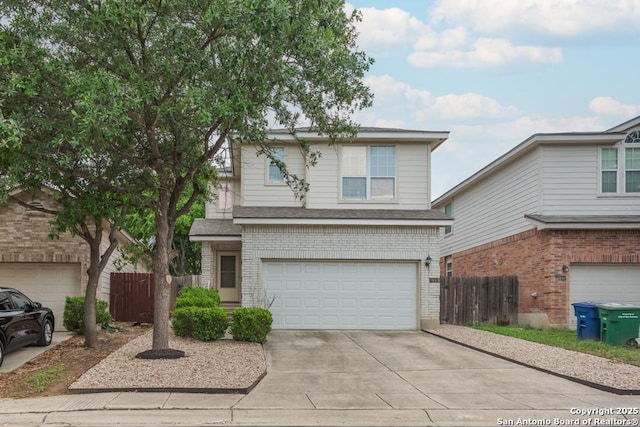 traditional-style home featuring a garage, brick siding, fence, and concrete driveway