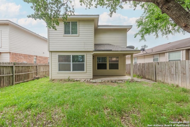 back of house featuring a yard, a fenced backyard, and a patio area