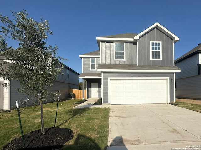 traditional-style house featuring a front lawn, a garage, concrete driveway, and fence