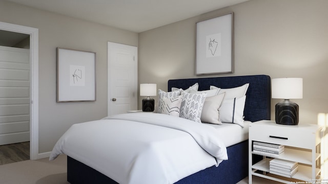 bedroom with wood finished floors and baseboards