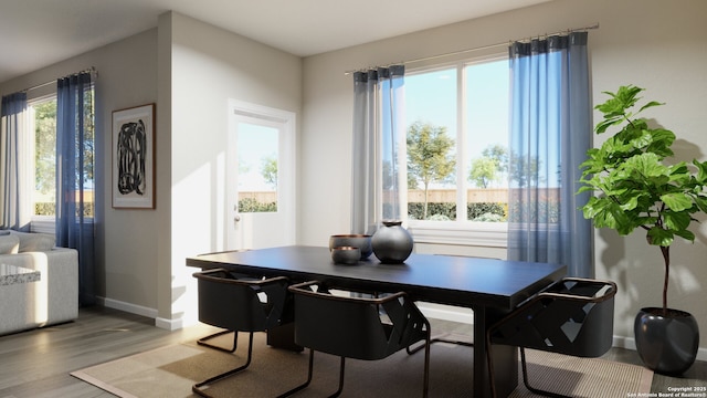 dining area featuring wood finished floors and baseboards