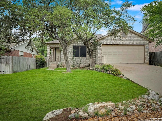 view of front of property featuring brick siding, fence, a front yard, concrete driveway, and an attached garage