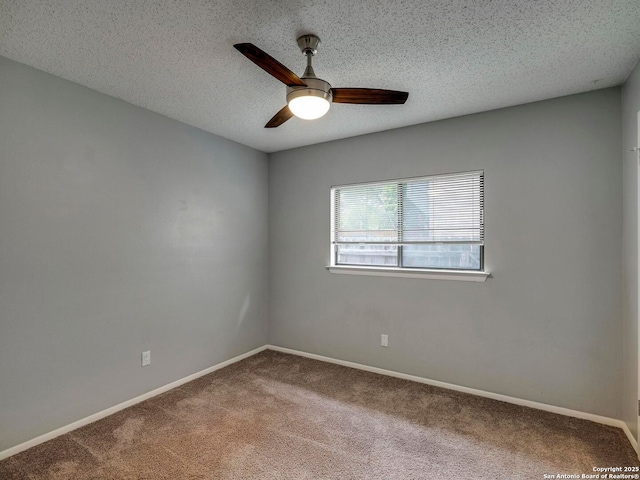 empty room with a ceiling fan, carpet flooring, a textured ceiling, and baseboards