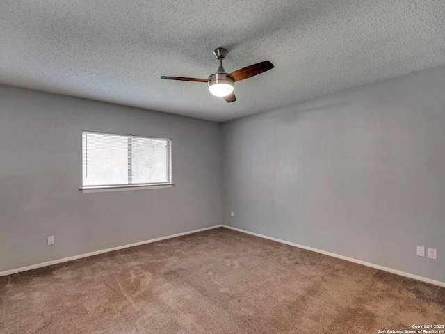 carpeted spare room with a textured ceiling, ceiling fan, and baseboards