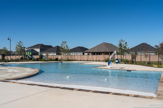 community pool featuring fence and a patio area
