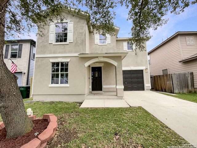 view of front facade with driveway, fence, stucco siding, a front lawn, and a garage