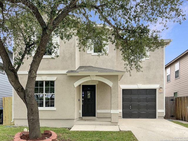 view of front of home featuring fence, stucco siding, concrete driveway, and an attached garage