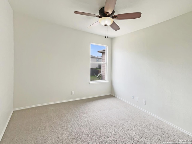 spare room featuring ceiling fan, carpet floors, and baseboards