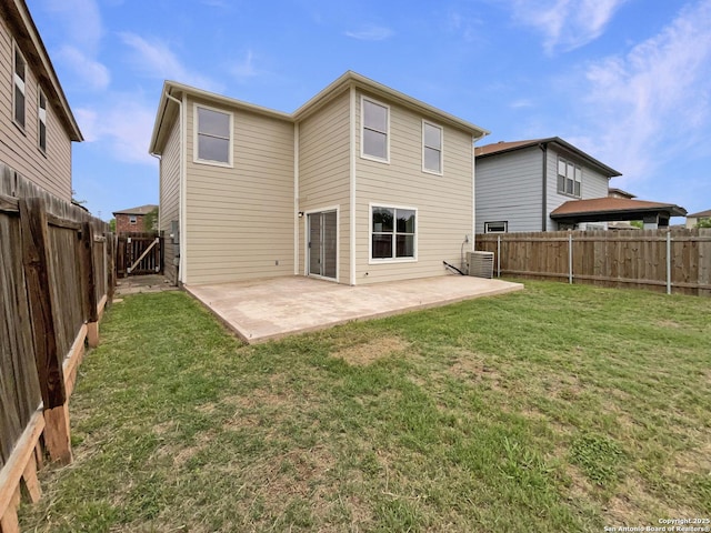 back of property with a patio, a yard, a fenced backyard, and central AC unit