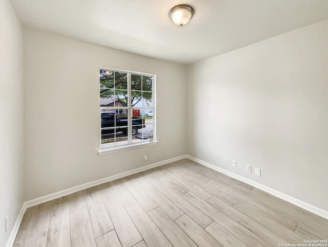 empty room with wood finished floors and baseboards