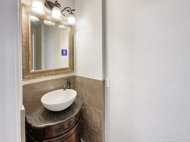 bathroom with tile walls and a sink